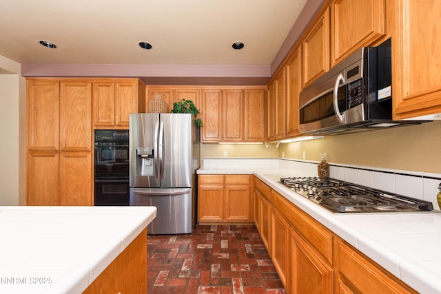 2080 St George Way, Carson City, NV 89703 - kitchen with appliances with stainless steel finishes, tile counters, brick patterned flooring, and recessed lighting
