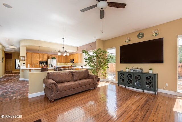 2080 St George Way, Carson City, NV 89703 - living area featuring a ceiling fan, baseboards, hardwood / wood-style floors, and a chandelier