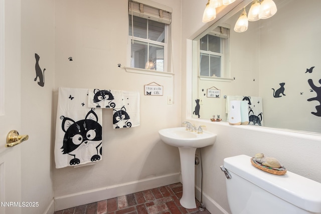 2080 St George Way, Carson City, NV 89703 - bathroom with baseboards, brick floors, toilet, and a sink