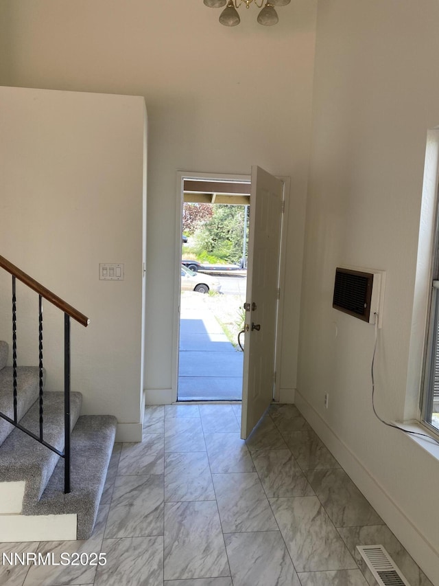 1070 Big Springs Rd, Reno, NV 89523 - foyer featuring light marble finish flooring, stairway, baseboards, and a wall unit AC