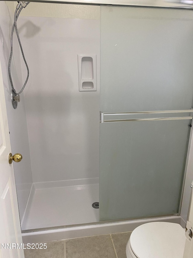 1070 Big Springs Rd, Reno, NV 89523 - bathroom featuring a stall shower, tile patterned floors, and toilet