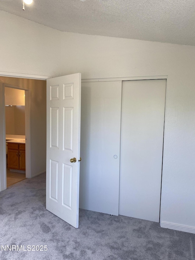 1070 Big Springs Rd, Reno, NV 89523 - unfurnished bedroom featuring carpet floors, a closet, and a textured ceiling