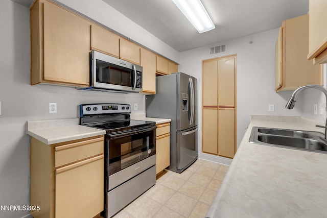 6850 Sharlands Ave Unit Ac2179, Reno, NV 89523 - kitchen featuring appliances with stainless steel finishes, a sink, light countertops, and light brown cabinets