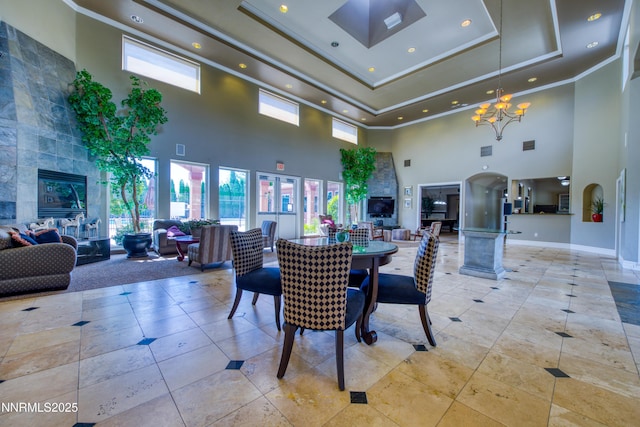 6850 Sharlands Ave Unit Ac2179, Reno, NV 89523 - dining space featuring a towering ceiling, a chandelier, recessed lighting, a tray ceiling, and a high end fireplace