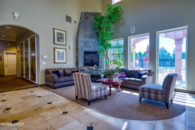 6850 Sharlands Ave Unit Ac2179, Reno, NV 89523 - living room with a high ceiling, arched walkways, and a tiled fireplace