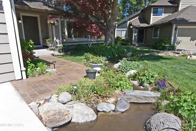 4115 Willowsprings Ct, Reno, NV 89519 - view of grassy yard featuring a garden pond and a porch