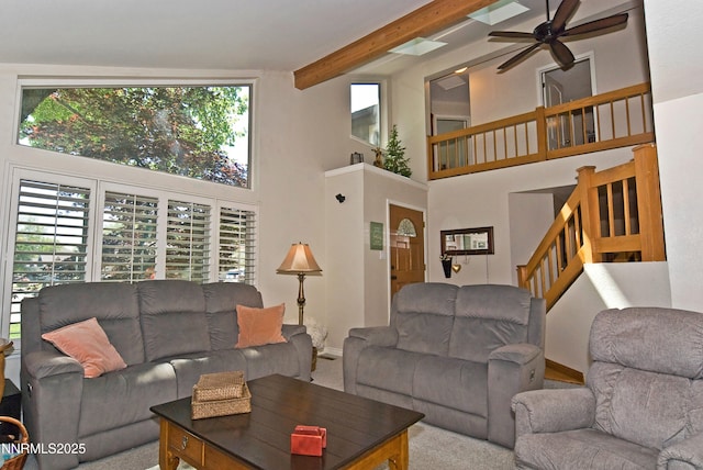 4115 Willowsprings Ct, Reno, NV 89519 - carpeted living room featuring ceiling fan, a high ceiling, stairs, beam ceiling, and baseboards