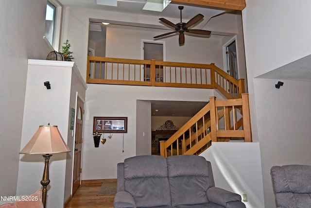 4115 Willowsprings Ct, Reno, NV 89519 - living room featuring stairway, wood finished floors, a ceiling fan, and a towering ceiling