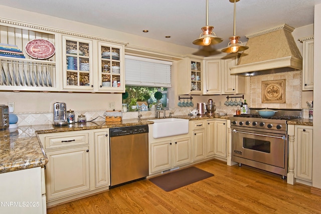 4115 Willowsprings Ct, Reno, NV 89519 - kitchen with appliances with stainless steel finishes, custom exhaust hood, a sink, cream cabinetry, and light wood-style floors