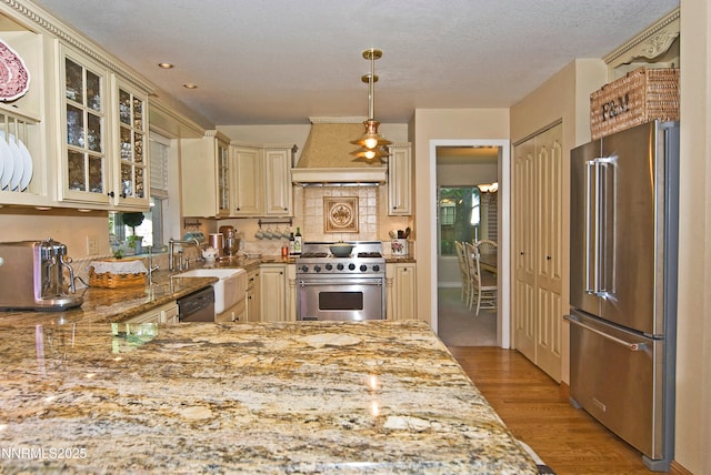 4115 Willowsprings Ct, Reno, NV 89519 - kitchen featuring high quality appliances, cream cabinets, custom range hood, a sink, and light wood-style flooring