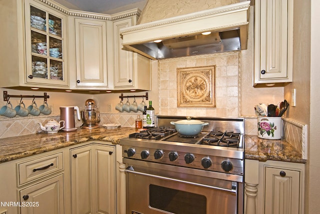 4115 Willowsprings Ct, Reno, NV 89519 - kitchen featuring cream cabinetry, high end range, custom exhaust hood, and backsplash