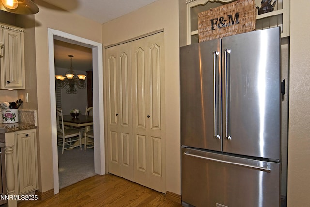 4115 Willowsprings Ct, Reno, NV 89519 - kitchen featuring high end fridge, cream cabinetry, wood finished floors, a chandelier, and a ceiling fan
