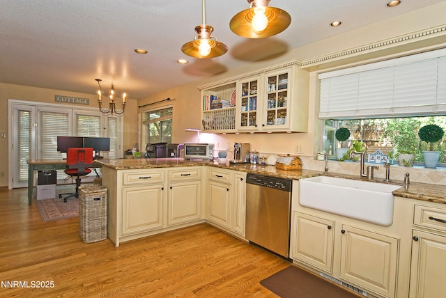 4115 Willowsprings Ct, Reno, NV 89519 - kitchen featuring dishwasher, cream cabinets, a sink, a chandelier, and a peninsula
