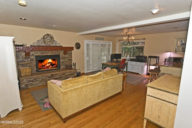 4115 Willowsprings Ct, Reno, NV 89519 - living area with wood finished floors, a textured ceiling, a fireplace, and a chandelier