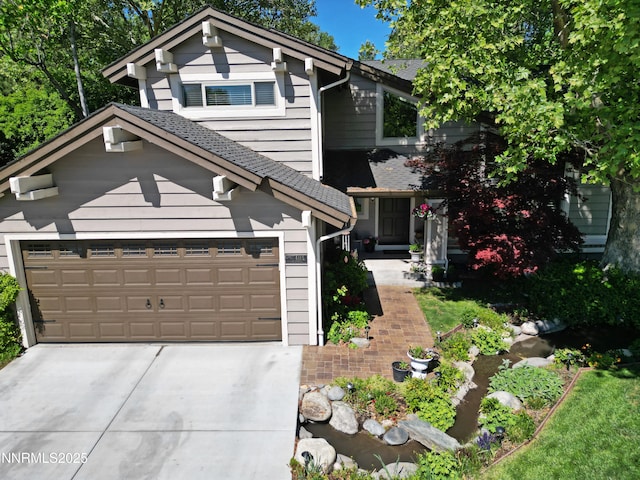 4115 Willowsprings Ct, Reno, NV 89519 - view of front of home featuring a shingled roof, concrete driveway, an attached garage, and a garden pond