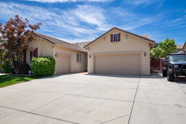 637 Donner Pass Ct, Sparks, NV 89436 - view of front of house with concrete driveway, an attached garage, stucco siding, and a tiled roof
