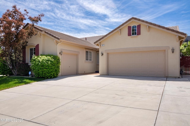 637 Donner Pass Ct, Sparks, NV 89436 - view of front of property with a garage, a tiled roof, driveway, and stucco siding