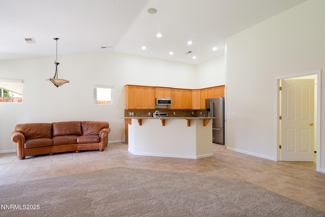 637 Donner Pass Ct, Sparks, NV 89436 - kitchen with stainless steel appliances, open floor plan, light tile patterned flooring, a breakfast bar, and hanging light fixtures