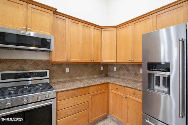 637 Donner Pass Ct, Sparks, NV 89436 - kitchen with appliances with stainless steel finishes, backsplash, light stone counters, and light tile patterned floors