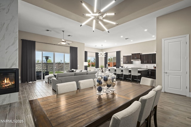 9425 Stony Hill Rd, Reno, NV 89521 - dining space featuring a chandelier, wood finished floors, a premium fireplace, and recessed lighting