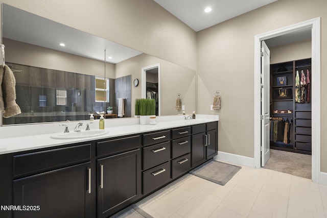 9425 Stony Hill Rd, Reno, NV 89521 - full bath featuring double vanity, a walk in closet, a tile shower, baseboards, and recessed lighting