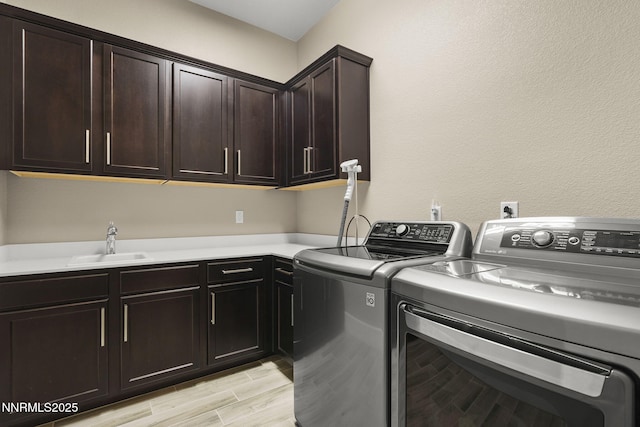 9425 Stony Hill Rd, Reno, NV 89521 - laundry room featuring separate washer and dryer, cabinet space, and light wood-type flooring