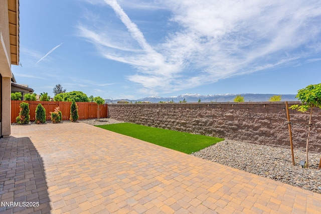 9425 Stony Hill Rd, Reno, NV 89521 - fenced backyard featuring a patio and a mountain view
