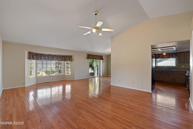 439 Beau Ct, Sparks, NV 89436 - unfurnished living room with lofted ceiling, ceiling fan, light wood-style flooring, and baseboards