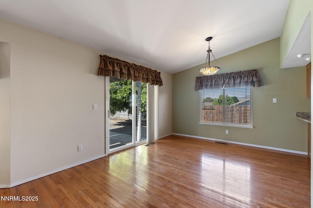 439 Beau Ct, Sparks, NV 89436 - spare room featuring plenty of natural light, wood finished floors, vaulted ceiling, and baseboards