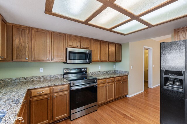 439 Beau Ct, Sparks, NV 89436 - kitchen featuring stainless steel appliances, brown cabinetry, and light wood finished floors