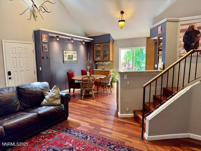 3205 Kingsview Ct, Reno, NV 89512 - living room with wood finished floors, stairway, baseboards, a chandelier, and high vaulted ceiling
