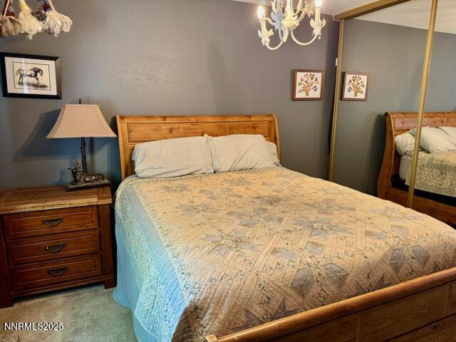 3205 Kingsview Ct, Reno, NV 89512 - bedroom featuring a closet, a chandelier, and light carpet