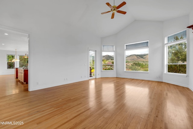 615 Oxbow Ct, Reno, NV 89511 - unfurnished living room featuring ceiling fan, light wood-style flooring, high vaulted ceiling, baseboards, and recessed lighting