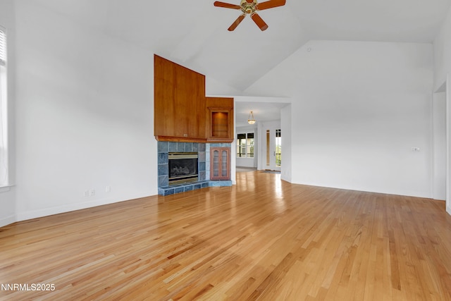 615 Oxbow Ct, Reno, NV 89511 - unfurnished living room with high vaulted ceiling, ceiling fan, light wood-style flooring, and a fireplace