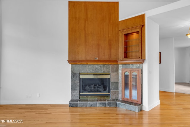 615 Oxbow Ct, Reno, NV 89511 - detailed view of baseboards, wood finished floors, and a fireplace
