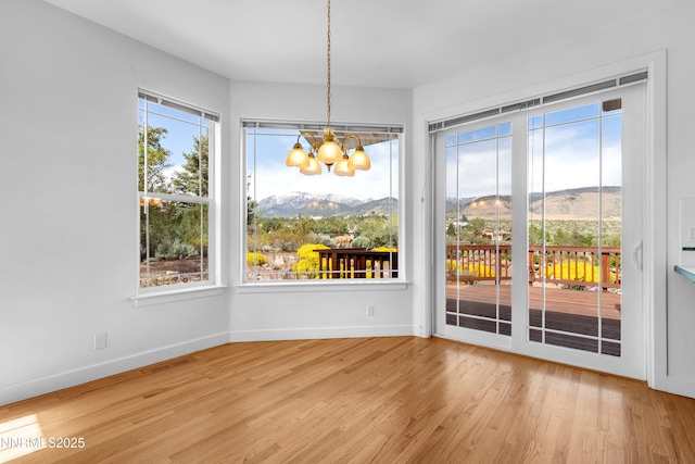 615 Oxbow Ct, Reno, NV 89511 - unfurnished dining area featuring a chandelier, wood finished floors, and baseboards