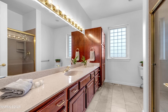 615 Oxbow Ct, Reno, NV 89511 - full bathroom featuring vanity, an enclosed shower, toilet, baseboards, and tile patterned floors