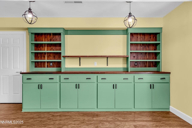 615 Oxbow Ct, Reno, NV 89511 - bar with light wood finished floors, baseboards, and pendant lighting