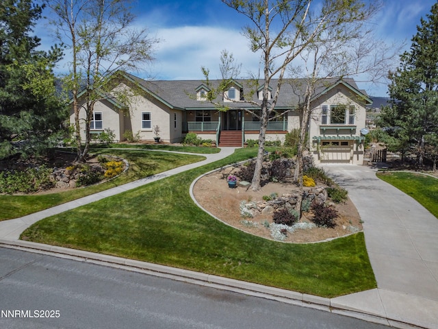 615 Oxbow Ct, Reno, NV 89511 - view of front of home with driveway, a front yard, an attached garage, stucco siding, and a porch