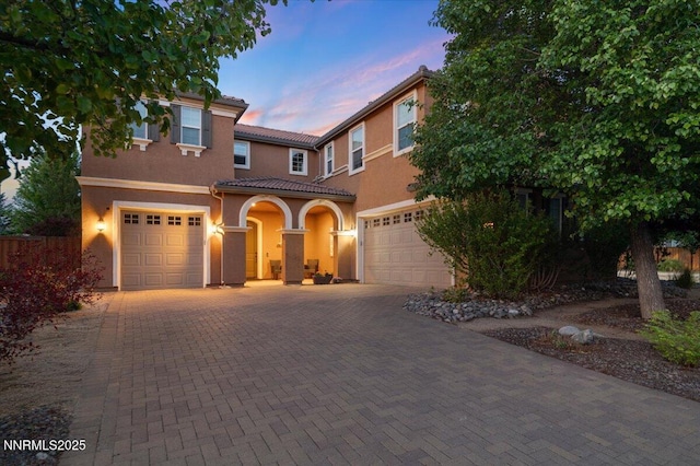 400 Sondrio Ct, Reno, NV 89521 - view of front facade featuring stucco siding, a tile roof, a garage, and decorative driveway