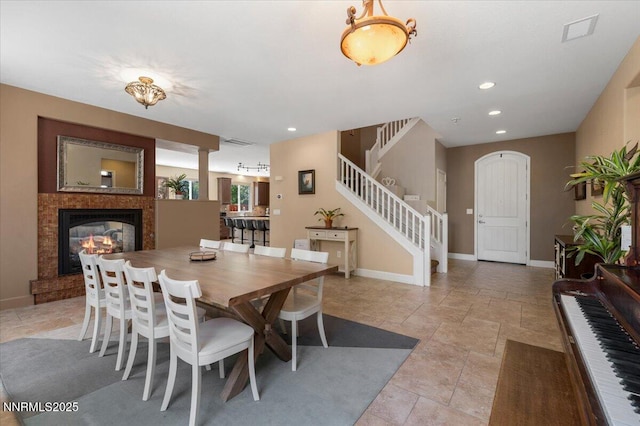 400 Sondrio Ct, Reno, NV 89521 - dining space featuring stairs, a glass covered fireplace, baseboards, and recessed lighting