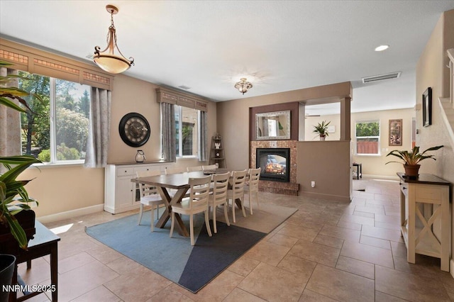 400 Sondrio Ct, Reno, NV 89521 - dining room with a brick fireplace, plenty of natural light, baseboards, and recessed lighting