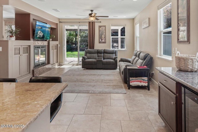 400 Sondrio Ct, Reno, NV 89521 - living room with ceiling fan, a glass covered fireplace, and light tile patterned floors