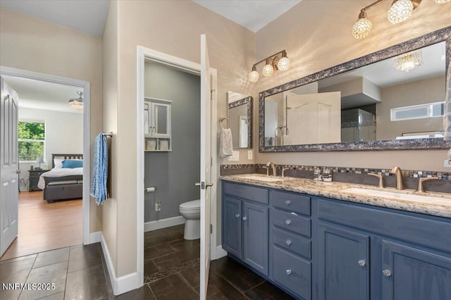 400 Sondrio Ct, Reno, NV 89521 - ensuite bathroom with double vanity, toilet, baseboards, and tile patterned flooring