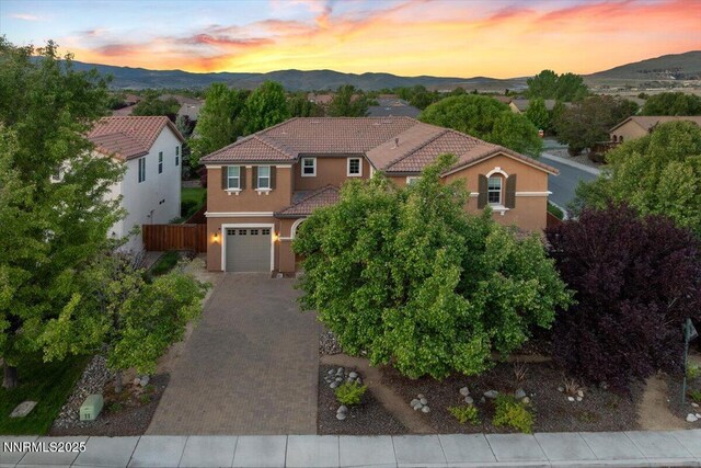 400 Sondrio Ct, Reno, NV 89521 - mediterranean / spanish-style house featuring decorative driveway, a tile roof, stucco siding, and a mountain view