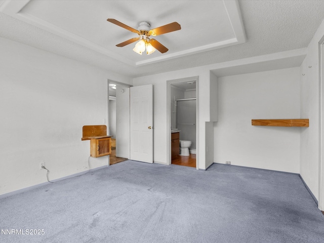 1344 Patricia Dr, Gardnerville, NV 89460 - unfurnished bedroom with a raised ceiling, carpet, connected bathroom, and ceiling fan