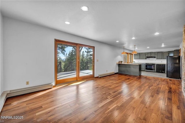 517 Driver Way, Incline Village, NV 89451 - unfurnished living room with hardwood / wood-style flooring, a baseboard heating unit, recessed lighting, and a baseboard radiator