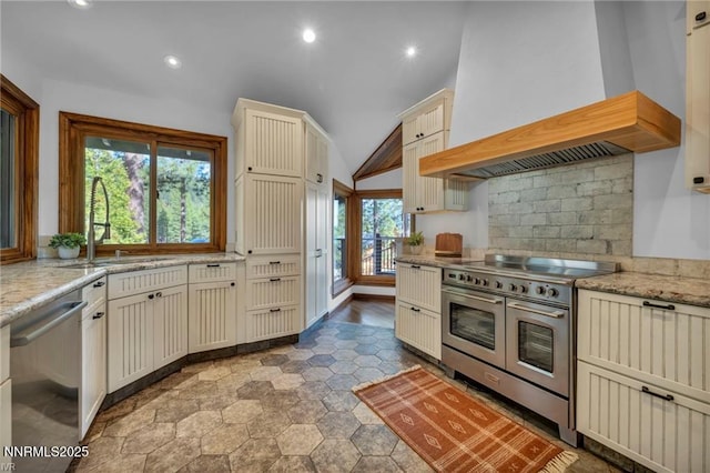 517 Driver Way, Incline Village, NV 89451 - kitchen featuring appliances with stainless steel finishes, cream cabinetry, custom range hood, recessed lighting, and vaulted ceiling