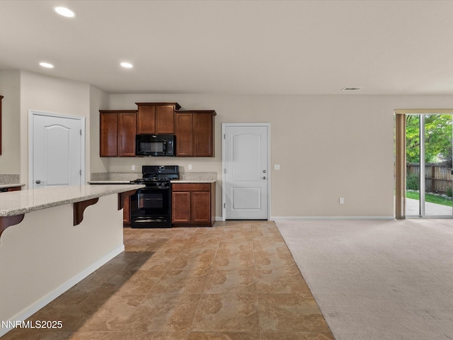 1105 Fiore Ct, Minden, NV 89423 - kitchen featuring black appliances, baseboards, a kitchen breakfast bar, light stone counters, and recessed lighting