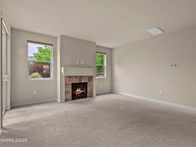 1105 Fiore Ct, Minden, NV 89423 - unfurnished living room featuring carpet floors, a tiled fireplace, and baseboards